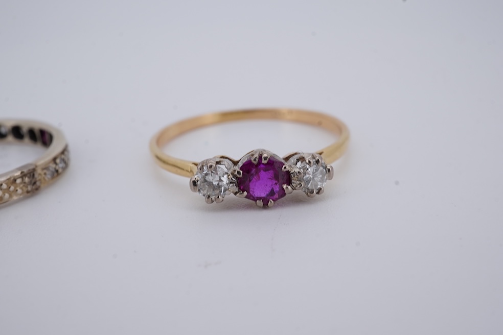 A yellow metal, stamped 18ct, ruby and diamond set three stone ring, size W, together with a yellow metal ruby and diamond set full eternity ring, size Q, gross weight 4.4 grams. Condition - poor to fair